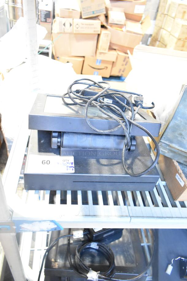 Stack of POS monitors, receipt printers, and wires on a metal shelf. Visible tag reads "QTY 10 PCS." Overall, items appear used.