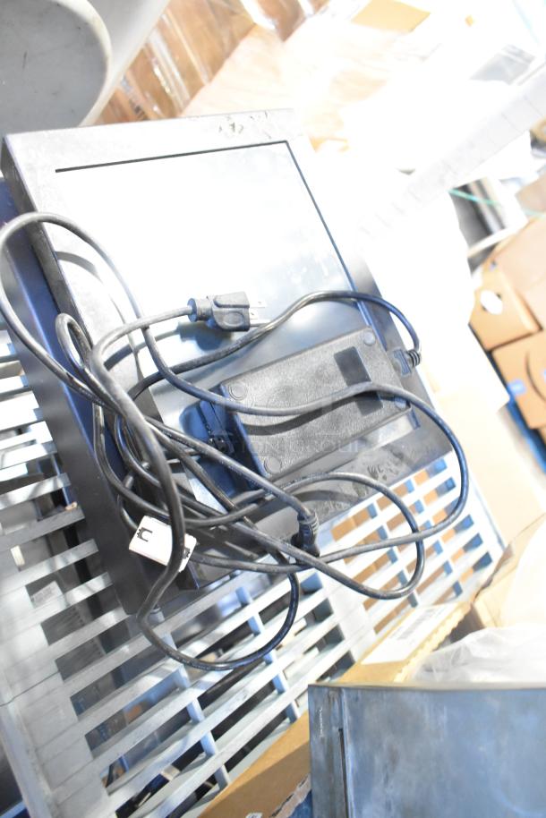POS monitor with power cables and adapters, part of a lot including receipt printers and wires. 10 items total, used condition.
