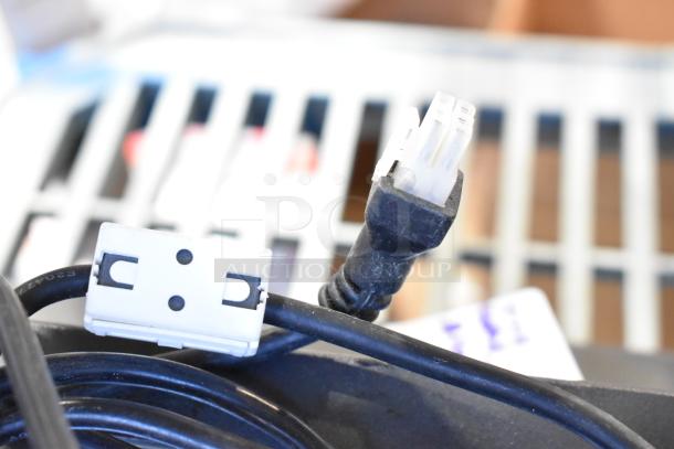 Close-up of various electronic cables and connectors, part of a lot including a POS monitor and receipt printers, 10 items total.