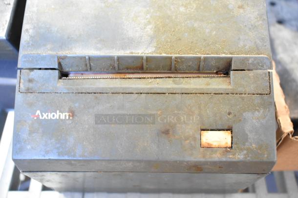 Axiom receipt printer, used, visible wear and rust. Includes Axiom branding. Part of auction lot with various items.