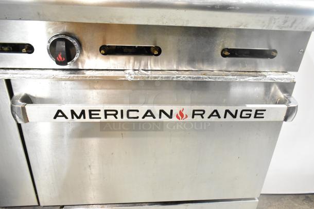 American Range commercial gas-powered 6 burner range with oven, over shelf, and backsplash. Features control knobs and visible branding.