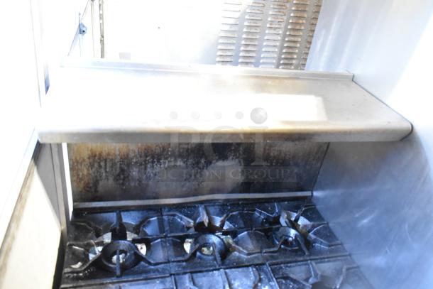 2016 American Range AR-6 commercial 6-burner gas range with oven, overshelf, and backsplash, showing wear and use.