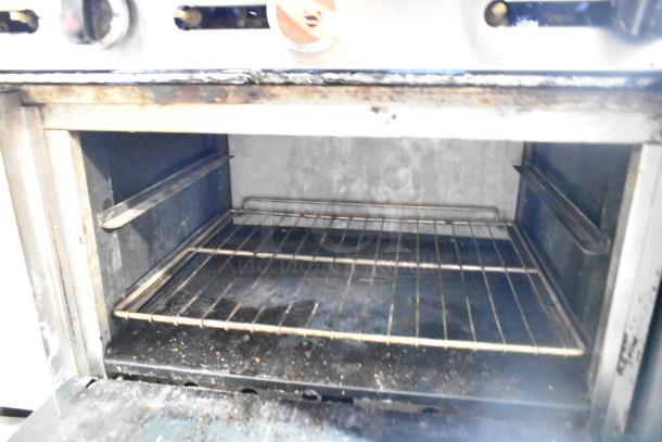 2016 American Range AR-6 commercial oven interior; steel racks, signs of use. Suitable for heavy-duty cooking tasks.