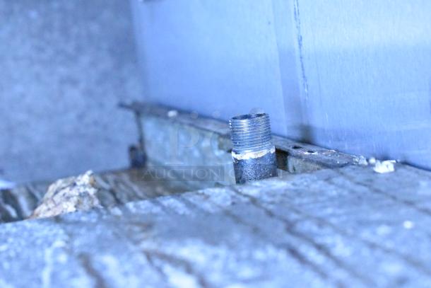 Close-up of metal pipe on a weathered surface, possibly related to the 2016 American Range AR-6 commercial gas range.