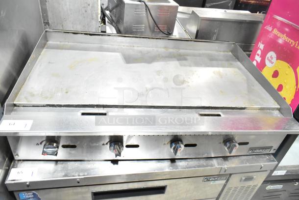 Dukers DCGMA48 countertop griddle, natural gas, 120,000 BTU. Stainless steel, used condition with visible signs of wear.