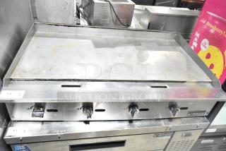 Dukers DCGMA48 countertop griddle, natural gas, 120,000 BTU. Stainless steel, used condition with visible signs of wear.