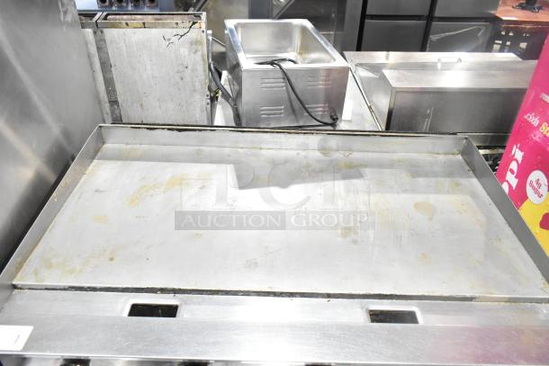 Dukers DCGMA48 commercial gas flat top griddle, 120,000 BTU, stainless steel, used condition with mild surface wear.