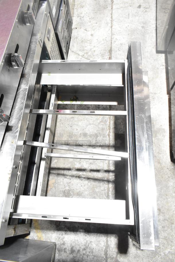 Dukers DCB48 commercial chef base with two drawers, stainless steel, on commercial casters. 115 volts, 1 phase, open drawers visible.