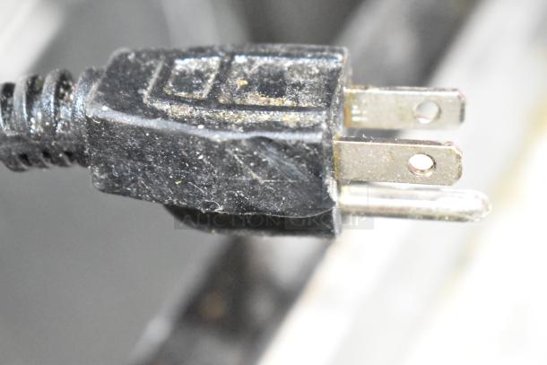 Close-up of a standard two-prong power plug for the Dukers DCB48 Chef Base, highlighting its connectivity condition.