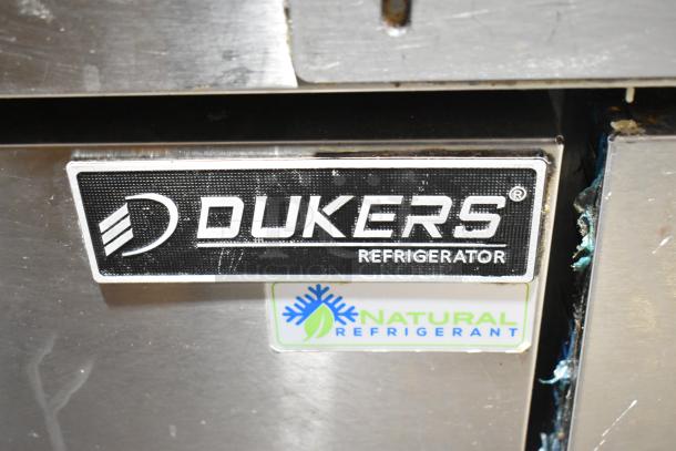 Dukers DCB48 commercial 2-drawer chef base with labels. Features natural refrigerant and commercial casters.