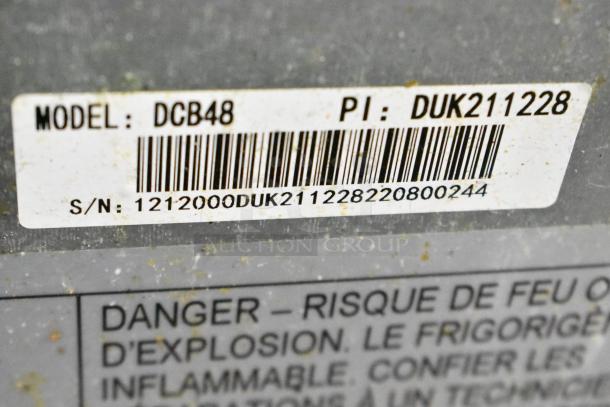 Barcode and serial number for Dukers DCB48 Commercial Chef Base. Model and PI: DUK211228 visible.