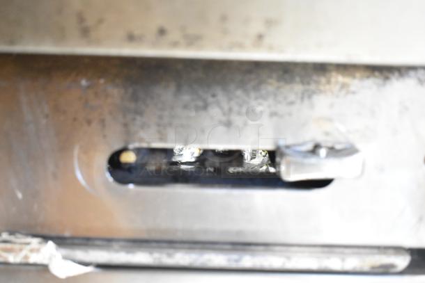 Close-up view of the American Range commercial gas-powered 6 burner range showing metal surface and structural details.