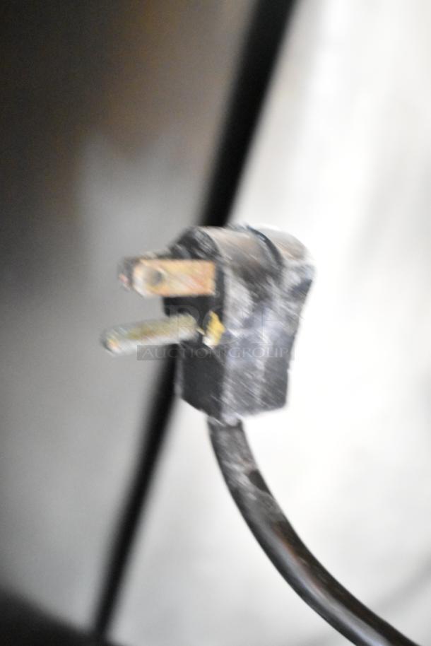 Close-up of a three-prong electrical plug for Beverage Air MT38 cooler, showing slight wear on the plug.