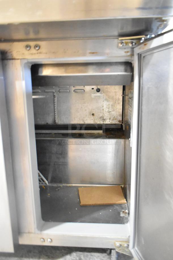 Continental DL36-15M commercial prep table interior view, stainless steel, on casters, 115 Volts, operational wear visible.