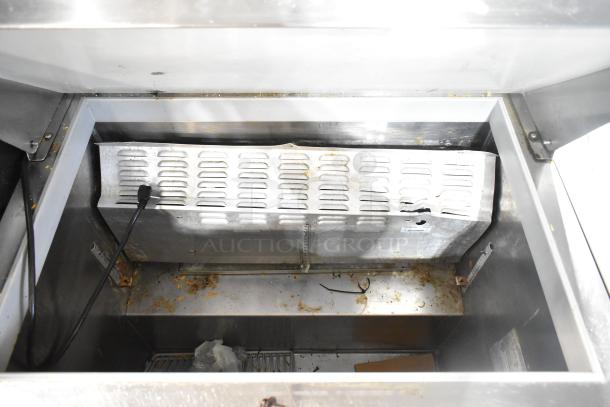 Continental DL36-15M sandwich prep table interior, showing electrical components and storage area, slightly worn condition.