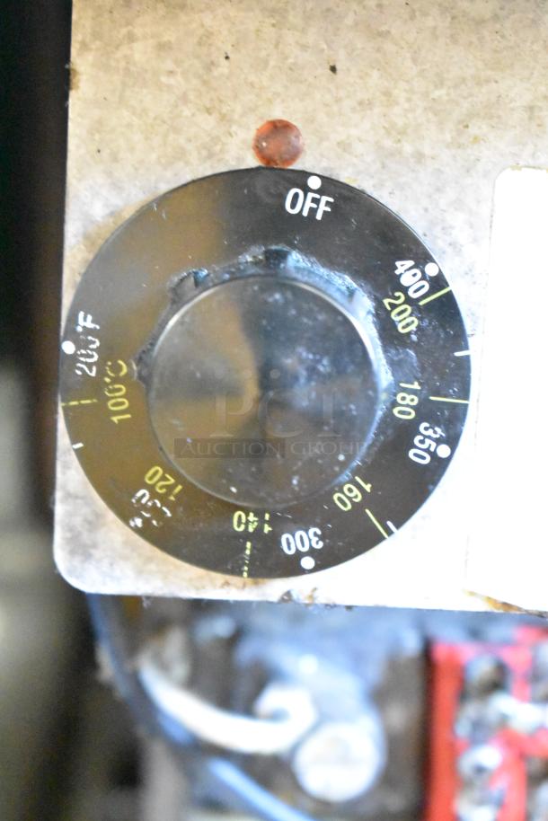 Temperature control dial of a Pitco Frialator SR14-S commercial deep fryer, showing temperature settings ranging from 100°C to 400°F.