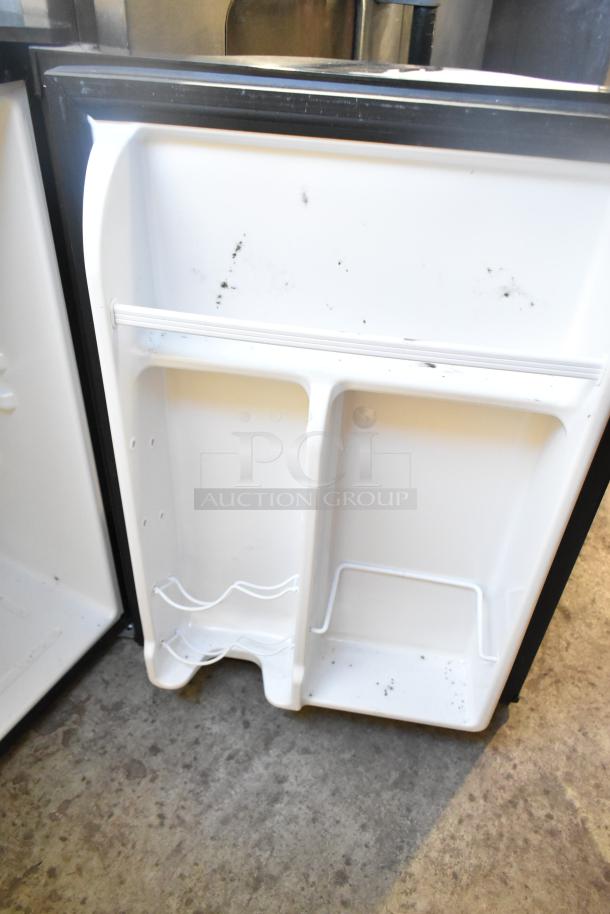 Magic Chef HMAR265BE Mini Cooler, 115V, 1 Phase, white interior with bottle rack, visible wear marks.