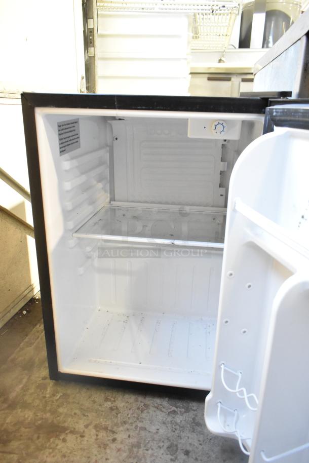 Magic Chef HMAR265BE Mini Cooler, 115V, 1 Phase. Open door view, clean interior with adjustable shelving, temperature dial visible.