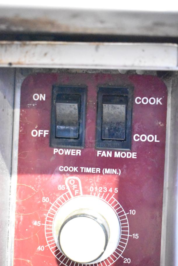 Close-up of Southbend commercial convection oven controls, showing power, fan mode switches, and a cook timer dial.