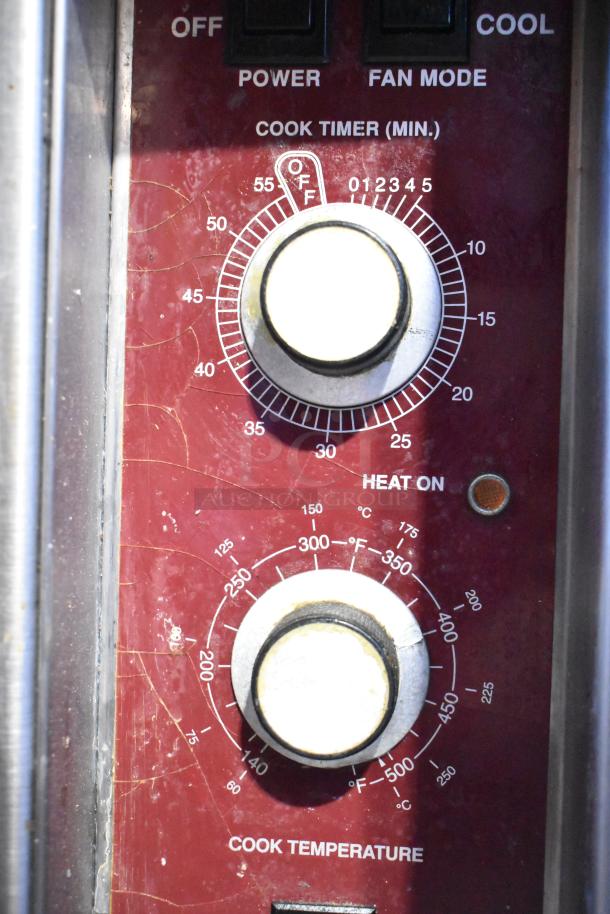 Southbend convection oven controls with two dials for timer and temperature settings. Visible wear and function labels.