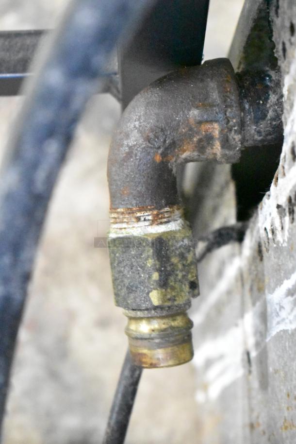 Close-up of a rusted gas pipe fitting connected to a Southbend commercial convection oven.
