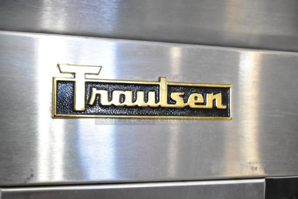 Traulsen logo on stainless steel surface of RLT232WUT-FHS commercial freezer. Doors need reattachment; missing hinges.
