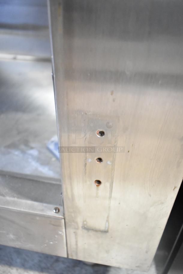 Traulsen RLT232WUT-FHS freezer, missing door hinges, 115V, 1 phase; close-up of frame with mounting holes visible.