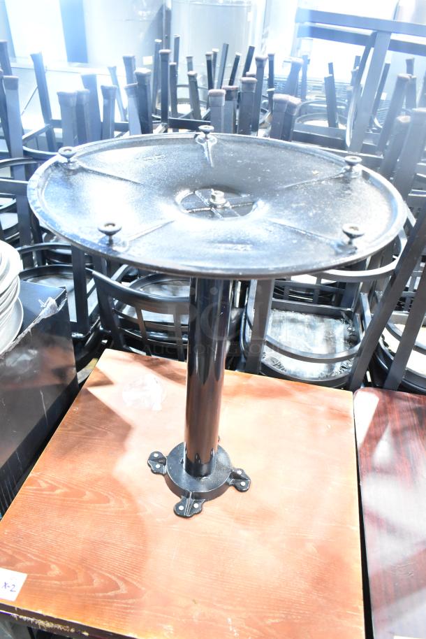 Two dining-height tables with wood pattern tabletops, metal bases, good condition. Ideal for restaurants or cafes.