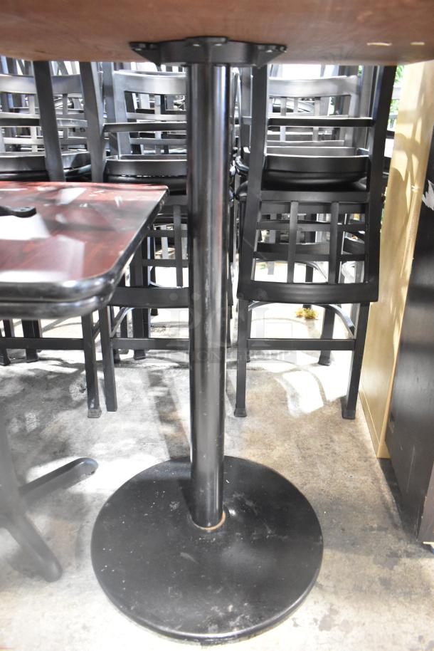 Two bar height tables with wood-patterned tabletops and sturdy metal bases. Great condition, ideal for commercial use.