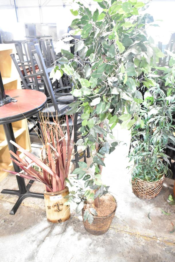 Two various fake plants in woven baskets; leafy branches and red foliage. Excellent condition, ideal for decor enhancement.