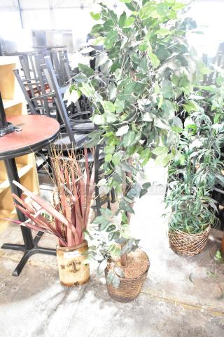 Two various fake plants in woven baskets; leafy branches and red foliage. Excellent condition, ideal for decor enhancement.