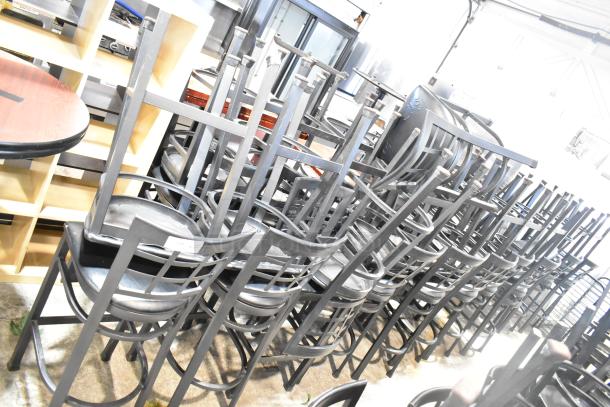 37 black bar height chairs with window back design and black seat cushions. Good condition. Auction lot includes all.