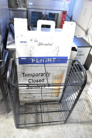Black wire shelving unit with multiple tiers and a white A-frame sidewalk sign featuring "Temporarily Closed."