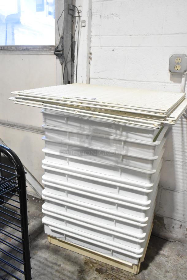 10 white ply dough bins stacked with 3 white finish racks on top. Clean condition, ideal for industrial baking use.