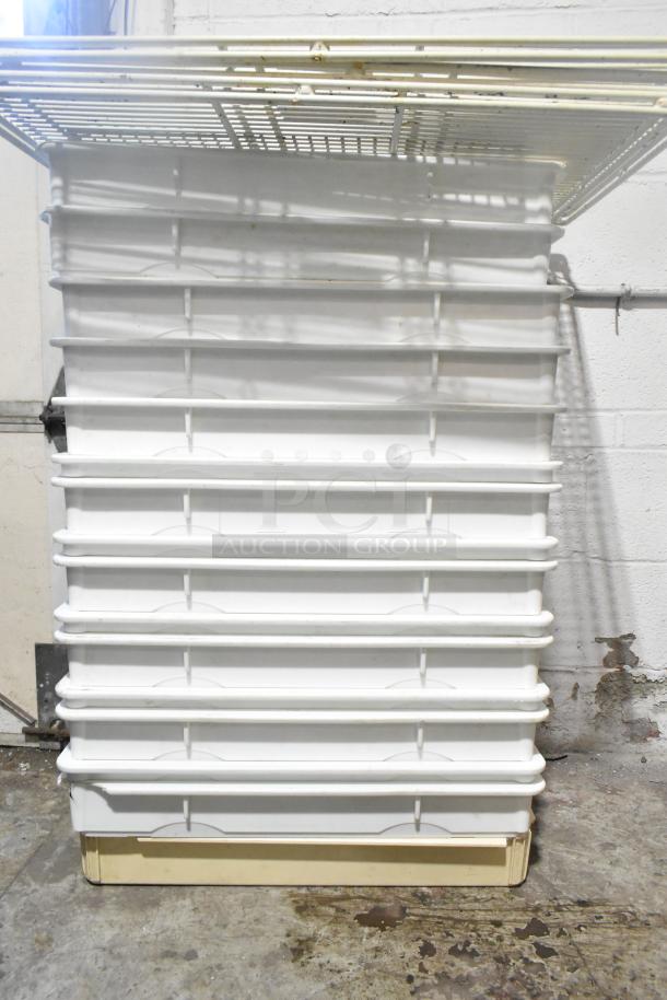 10 white ply dough bins stacked with 3 white finish racks. Durable, industrial-grade storage. Good condition.