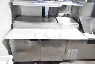 Beverage Air DP67 Commercial Pizza Prep Table with over shelf and casters. Stainless steel, 115V, 1 phase, label visible.