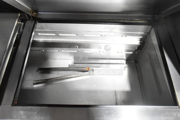 Beverage Air DP67 commercial pizza prep table, stainless steel interior, visible shelving and rails, used condition.