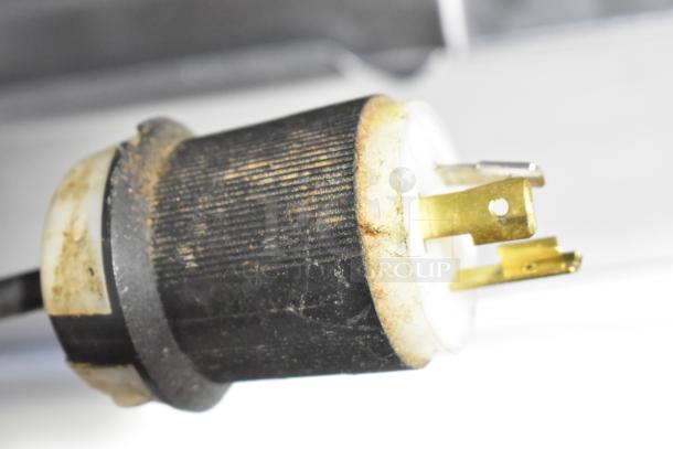 Close-up of a plug belonging to the Beverage Air DP67 Commercial Pizza Prep Table, showing minor wear. 115 Volts, 1 Phase.