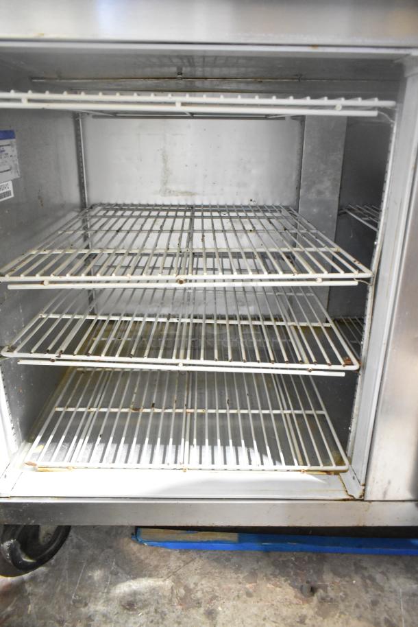 Beverage Air DP67 Commercial Pizza Prep Table, stainless steel, 115V, 1 Phase, over shelf, on commercial casters, interior view.