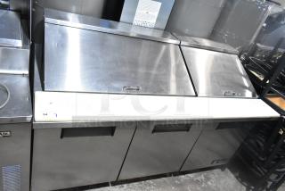 True TSSU-72-30M-B-ST sandwich salad prep table, stainless steel, commercial casters, 115V, 1 phase, good condition.