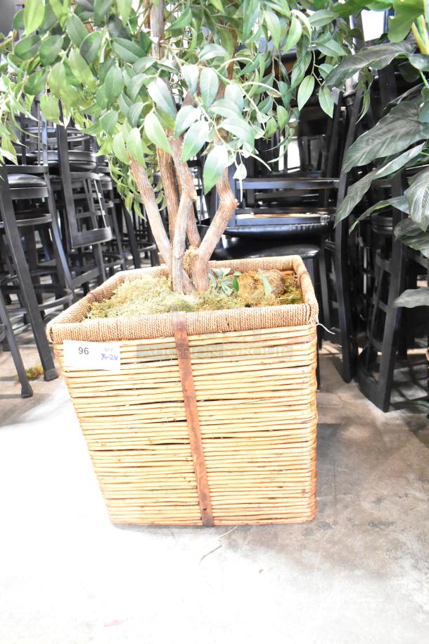 Artificial plant in woven basket, lush green leaves, tree-like trunk, good condition, label indicates '96 X24'.