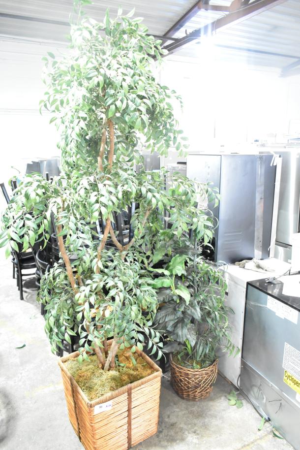 Two large fake plants in woven baskets, vibrant green foliage, excellent condition, ideal for home or office decor.