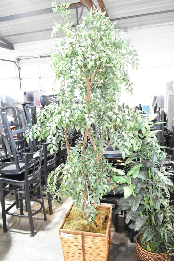 Two fake plants in woven baskets, featuring lush green foliage. Ideal for decor, with label indicating "2x your bid."