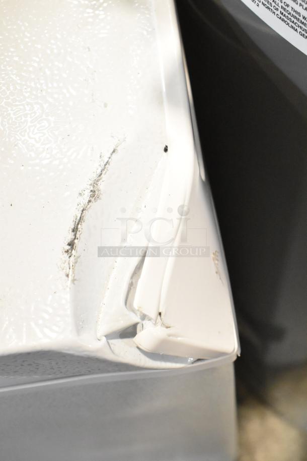 2025 Vissani HMCF7W5 chest freezer, 115 volts, 1 phase. Visible dent and scratch on white exterior, affecting condition.