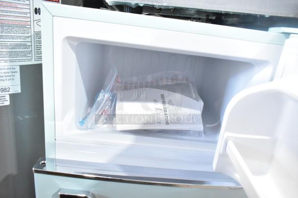 Brand new Frigidaire EFR840-MINT-6COM mini cooler with freezer, showing interior with manual and accessories. 115 Volts, 1 Phase.
