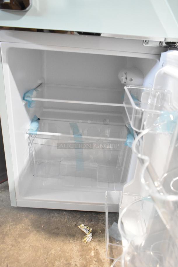 Brand new Frigidaire EFR840-MINT-6COM mini cooler with freezer, 115 volts, 1 phase, interior view showing shelves and storage.