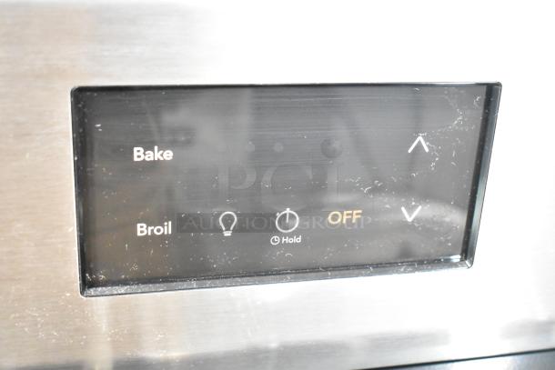 Frigidaire FCRG3052BSF control panel with "Bake," "Broil," light, timer, and temperature adjustment features visible.