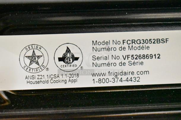 Frigidaire FCRG3052BSF natural gas 4-burner range with oven tag, model shown with serial No. VF52686912.