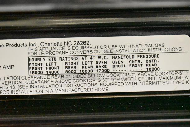 Frigidaire FCRG3052BSF Natural Gas Range with 4 Burners, oven, label shows BTU ratings and installation instructions.