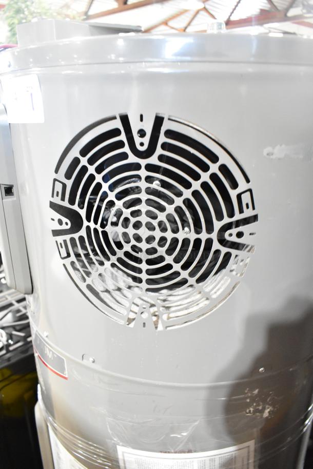 Rheem hot water heater, 208/240 volts; good condition, visible vent and labels, gray exterior.